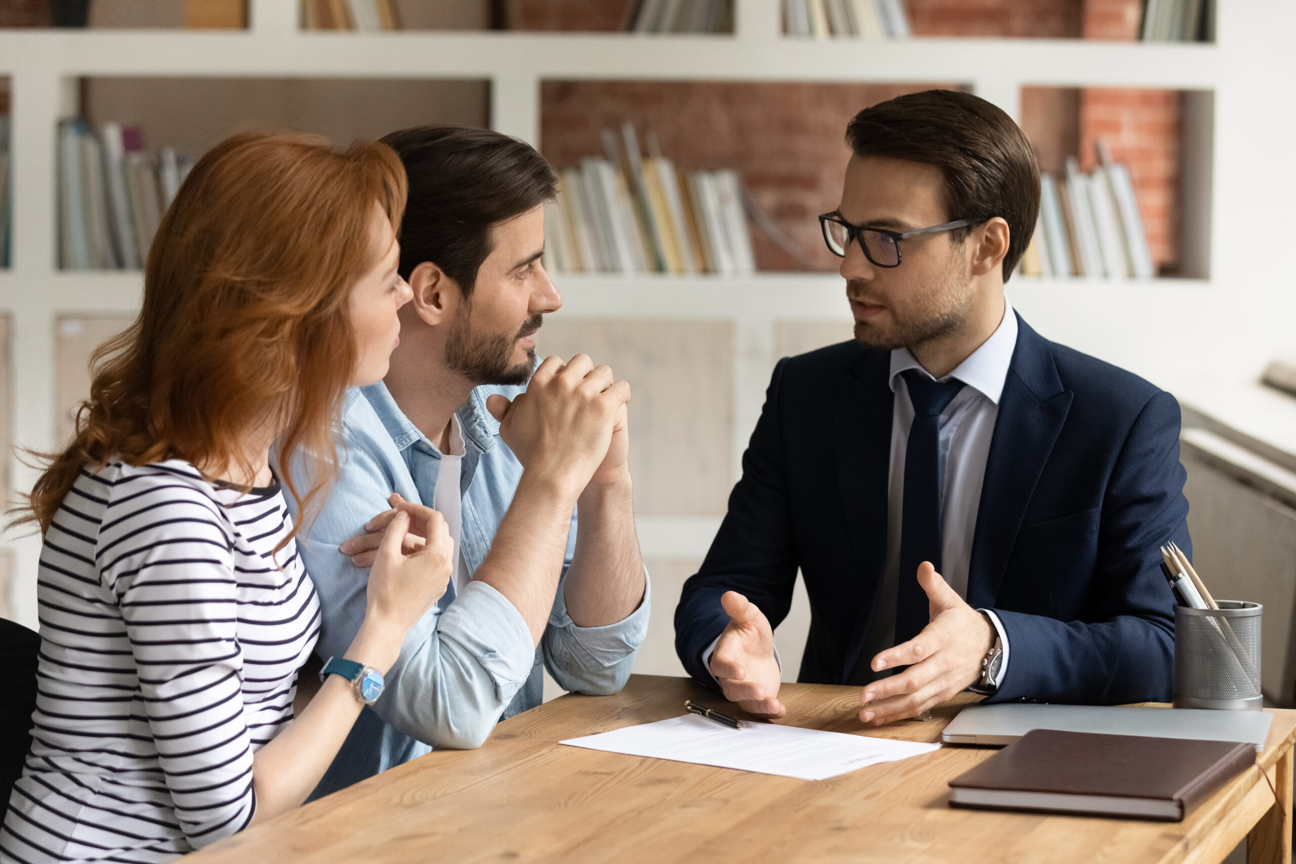 partnering with a knowledgeable attorney is paramount. Realtor sitting with clients